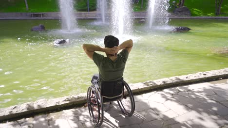 Happy-and-relaxed-young-man-sitting-in-his-wheelchair.